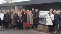 Gruppenfoto der Teilnehmenden vor dem Schild und Container der Fakultät Gesundheitswissenschaften.